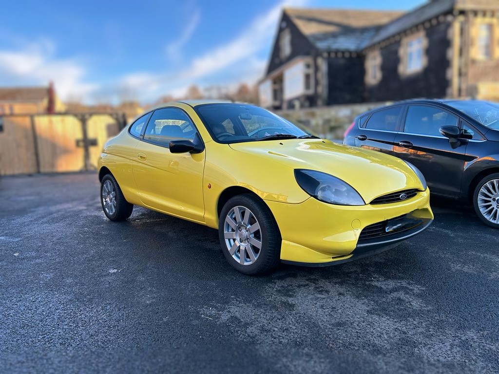 Customer's yellow Ford outside the Yeadon workshop